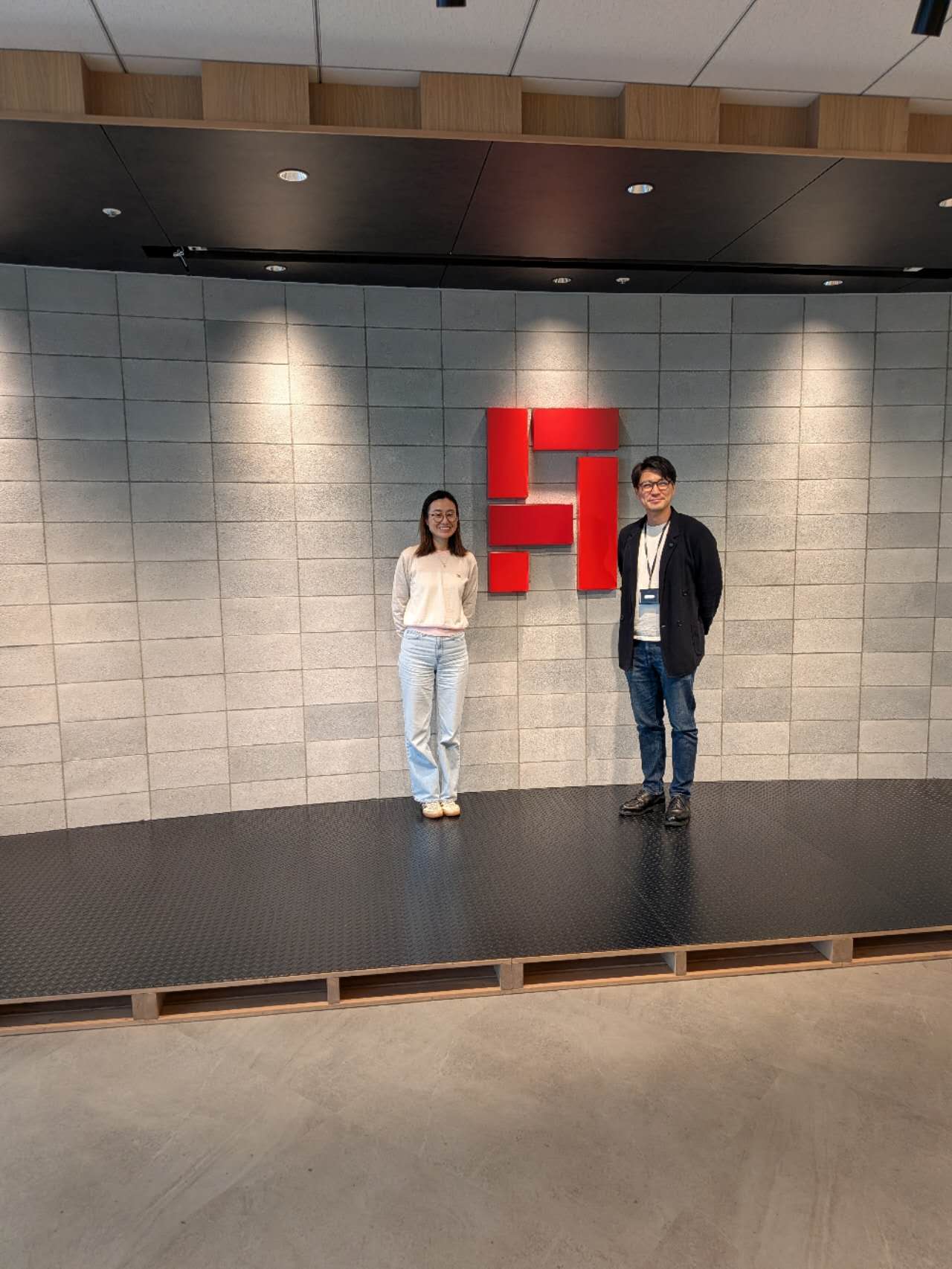 Visit to ANDPAD in Tokyo before Global Startup EXPO 2026. Two people standing in front of the ANDPAD logo at the company’s Tokyo office.